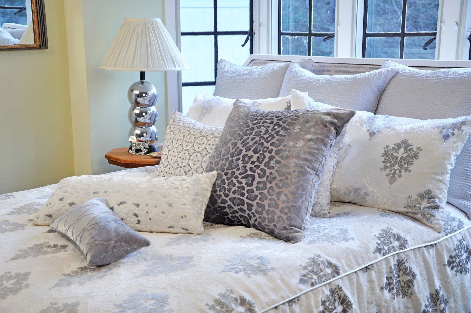 white bedding with throw pillows